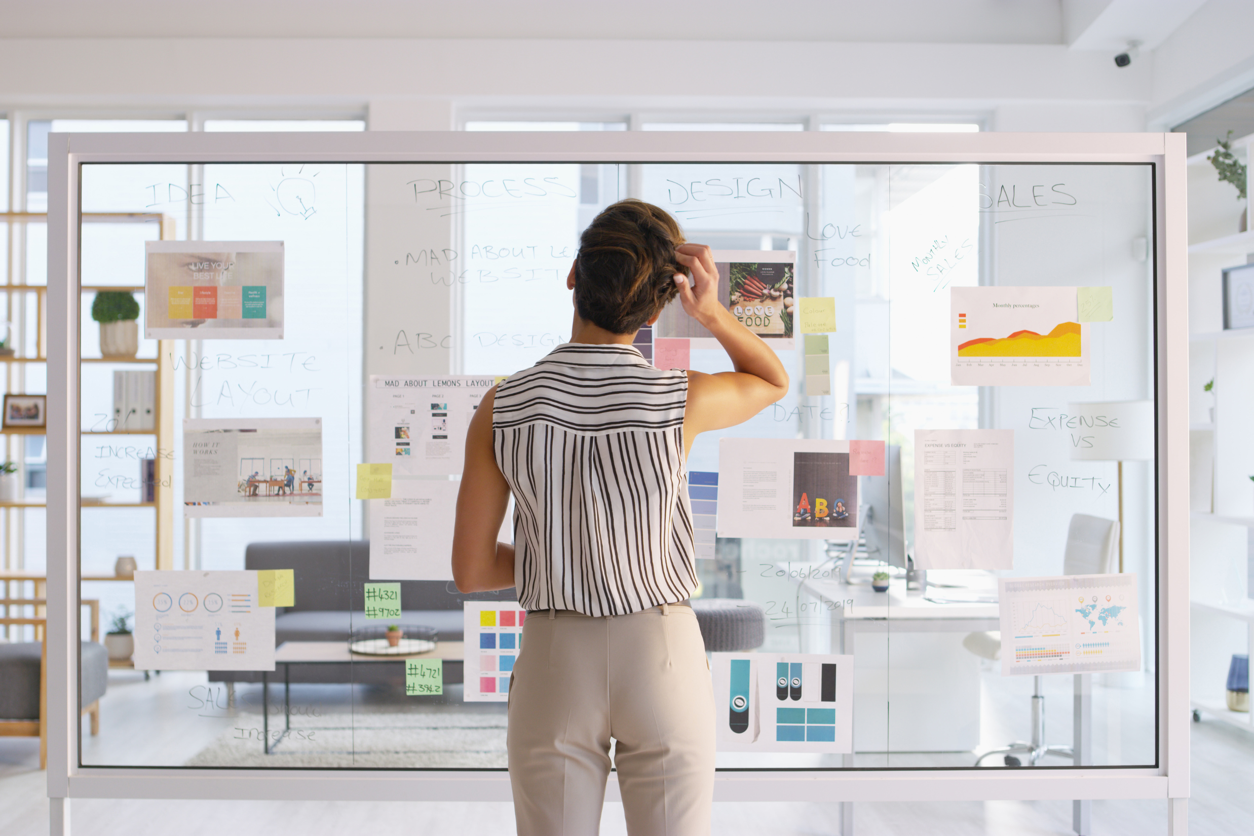 Decorative image of woman mapping out plan on a lightboard.