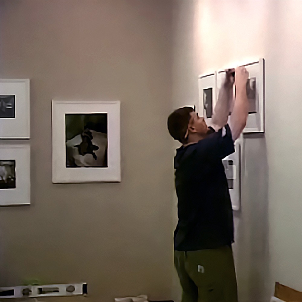 Image depicting Drew installing the inaugural Bruce Davidson show at 57th St.