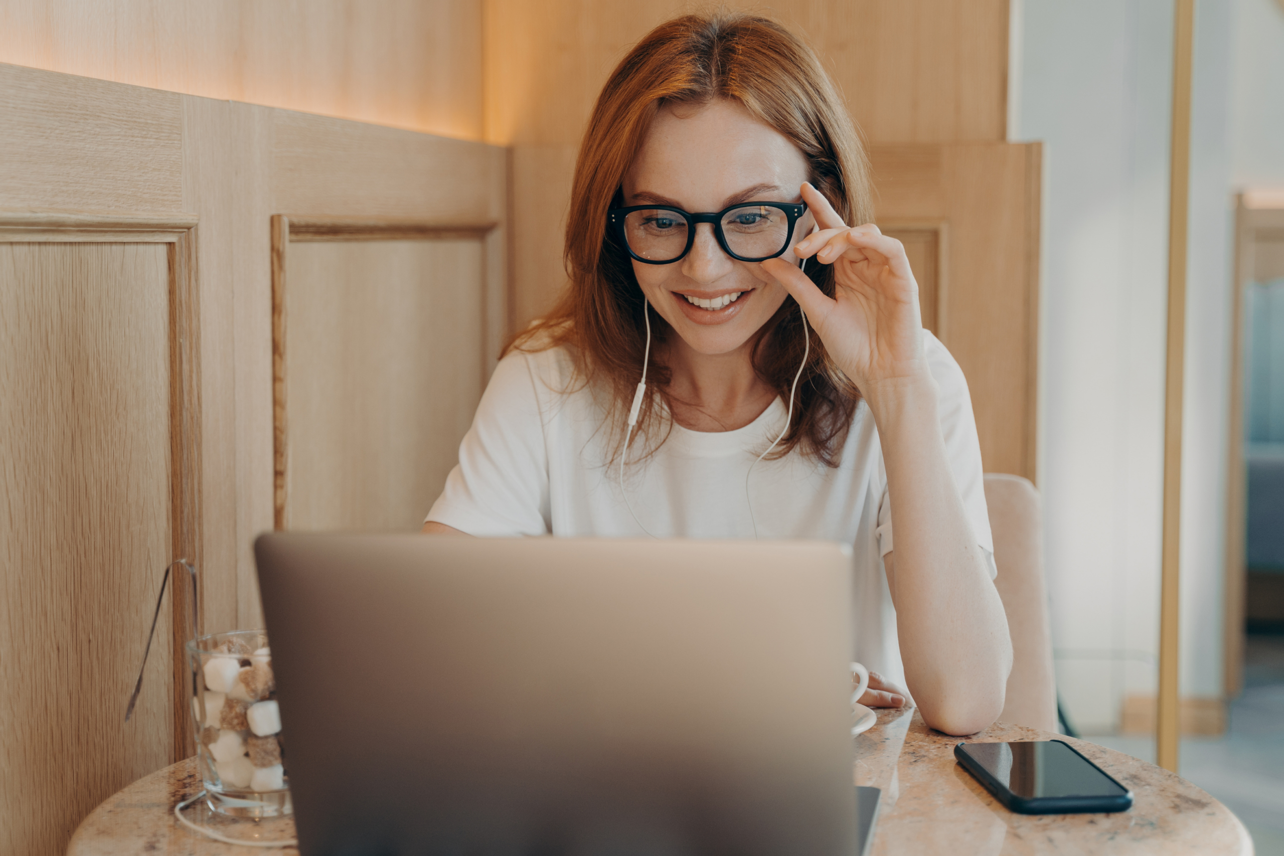 Decorative image of woman working on laptop.