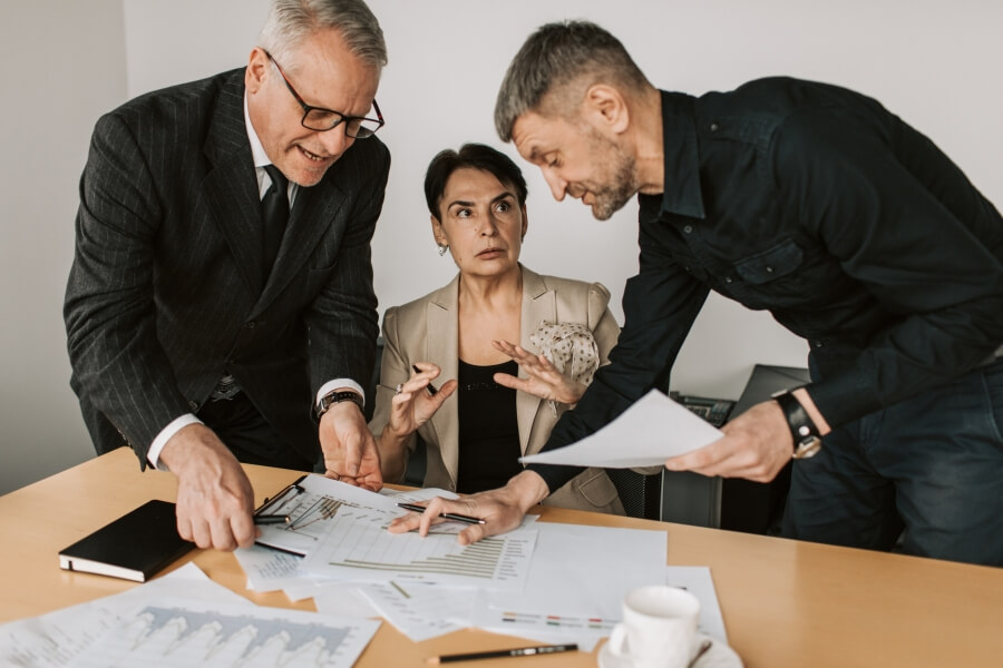 Decorative image of four colleagues meeting together.