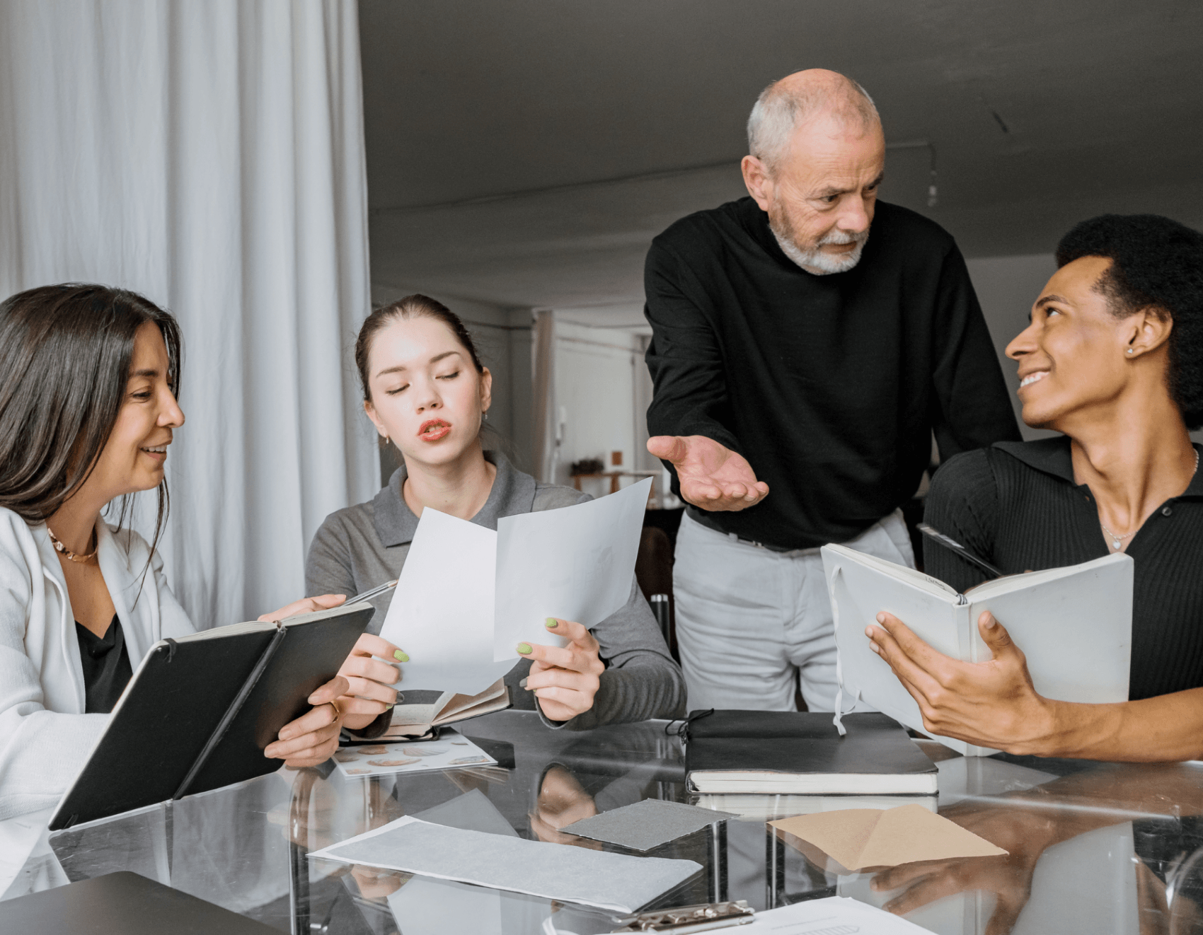 Decorative image of four colleagues meeting together.